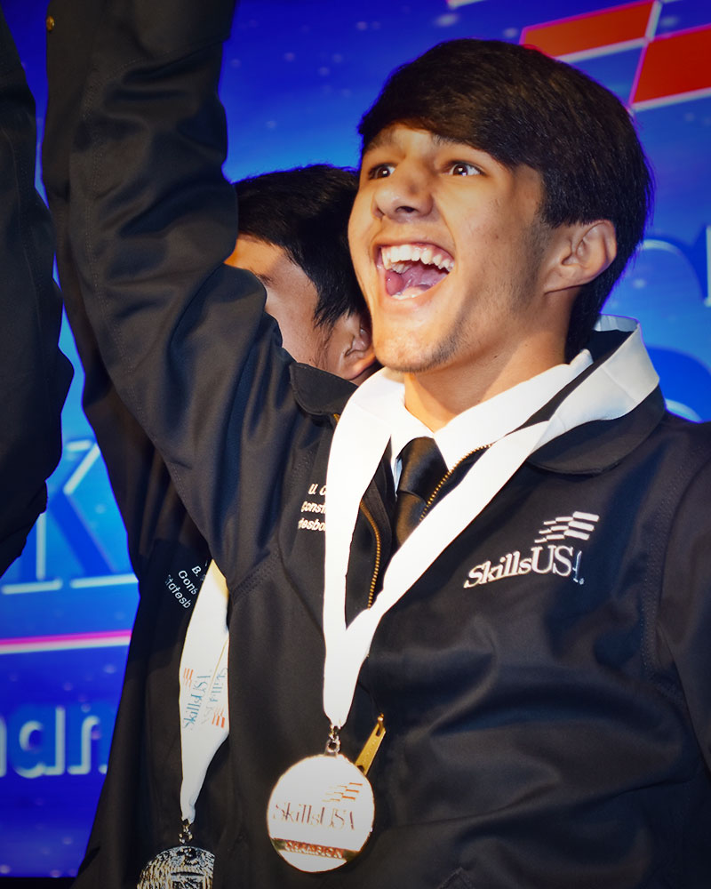 student with medal around neck